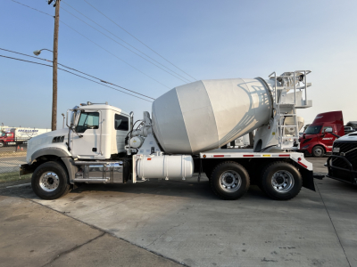 Concrete mixer truck side view showing cement mixer drum and mixer chute.