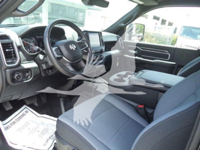 Ram 5500 interior with steering wheel on left, dashboard, center console, and front seats visible.