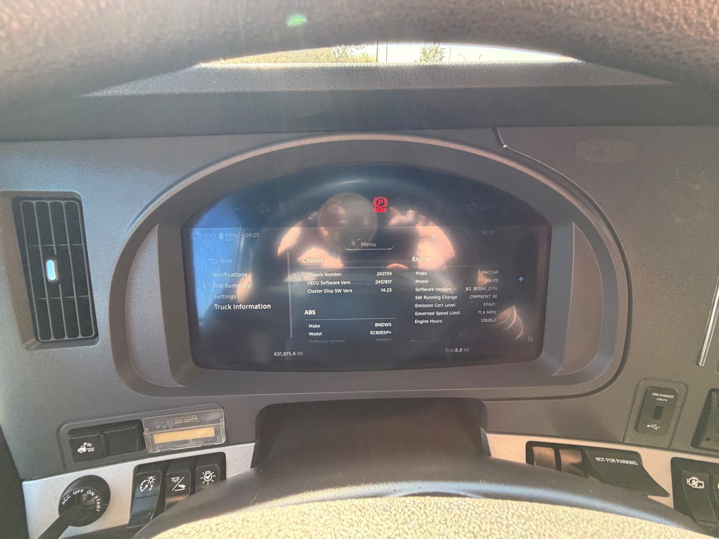 Kenworth T680 dashboard display showing vehicle information screen with odometer and status icons.