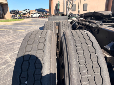 Kenworth T680 truck wheel area showing dual rear axles and tires with tread pattern