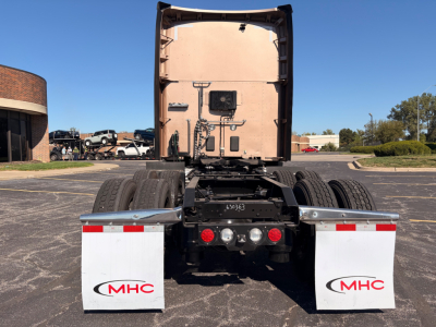 Kenworth T680 rear view showing chassis and rear mud flaps with MHC logos, fuel tanks on both sides, and rear bumper with lights.