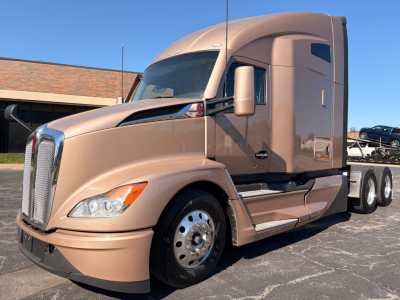 Kenworth T680 sleeper tractor in beige showing front and side; no text visible