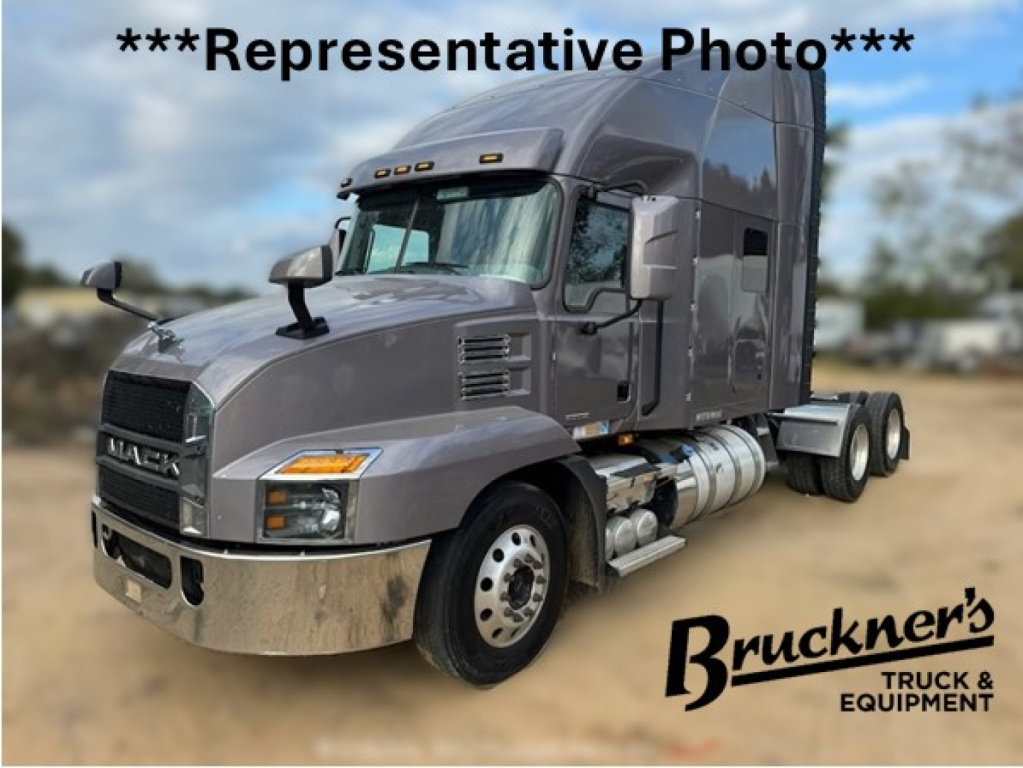 Mack AN64T70 truck in front view showing grille, headlights, sleeper cab, chrome bumper, fuel tanks, and dual rear axles._representation photo watermark Brunner's Truck & Equipment.