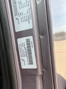 VIN/barcode stickers on door jamb of 2023 Mack AN64T70 conventional sleeper truck; visible text includes MAC T T RUCKS? Model tag and VIN label.