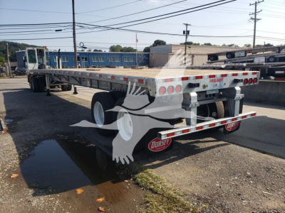 Flatbed trailer viewed from rear-left showing dual rear axles and white wheels, with Dorsey branding and bumper lights.