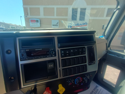 Dashboard view of a 2026 Mack MD7 truck cab showing steering wheel, radio, air vents, and control panel.