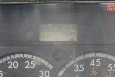 Dashboard view of a Freightliner FL70 cab and chassis showing gauge cluster and an hour meter reading 380303.4 hours.