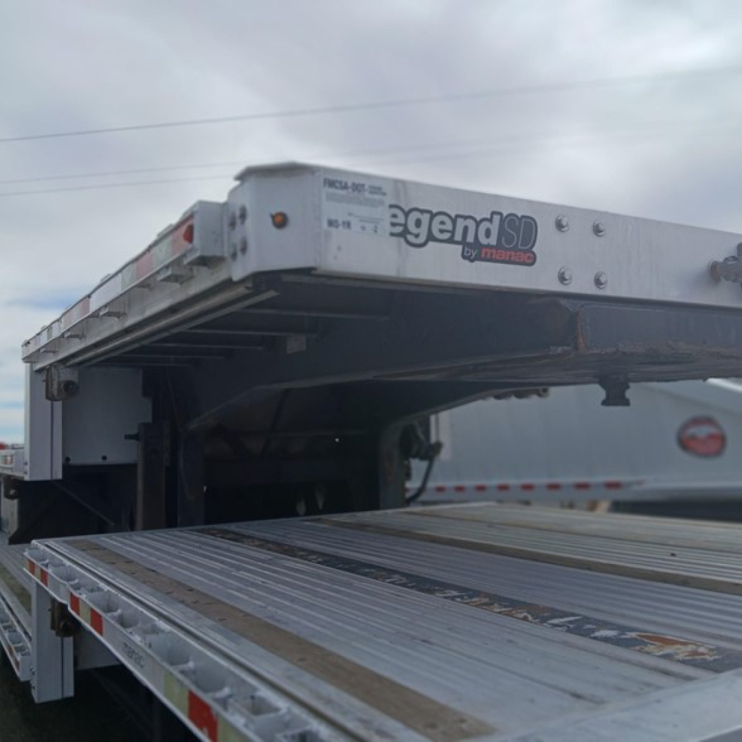 Manac Legend SD by Manac drop deck trailer showing steel deck and folded ramp sections with Legands SD branding