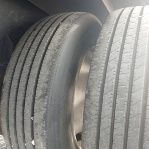 Trailer wheel/view showing dual tires and hub area of a Manac drop deck trailer.