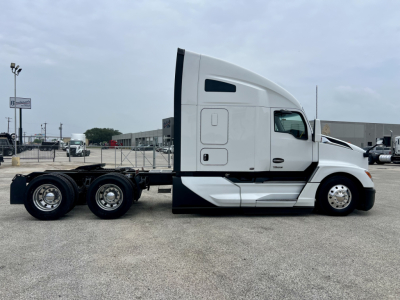 Kenworth T680 tractor in profile view showing day cab with sleeper area and chrome wheels, chassis, and rear axles.