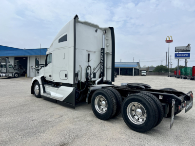 Kenworth T680 tractor in side view showing cab with sleeper, dual rear axles, and rear mud flaps.