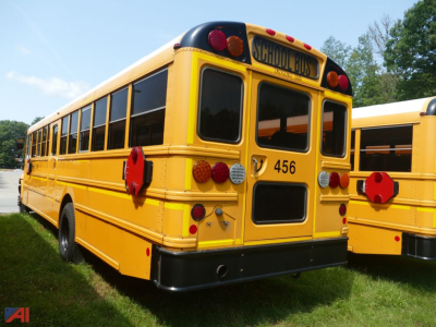 2019 International CE 3000 school bus rear view showing 'SCHOOL BUS' sign, bus number 456, and various red reflective emergency hardware on yellow exterior.