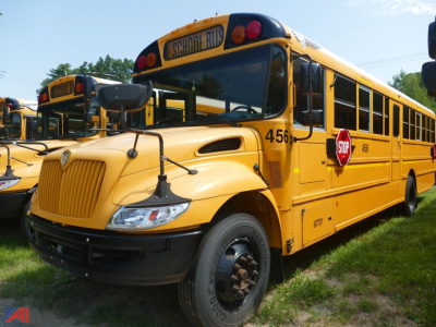Yellow school bus from side/front angle showing 'SCHOOL BUS' sign, stop sign, rear wheels, and bus number 456 on the front fender.