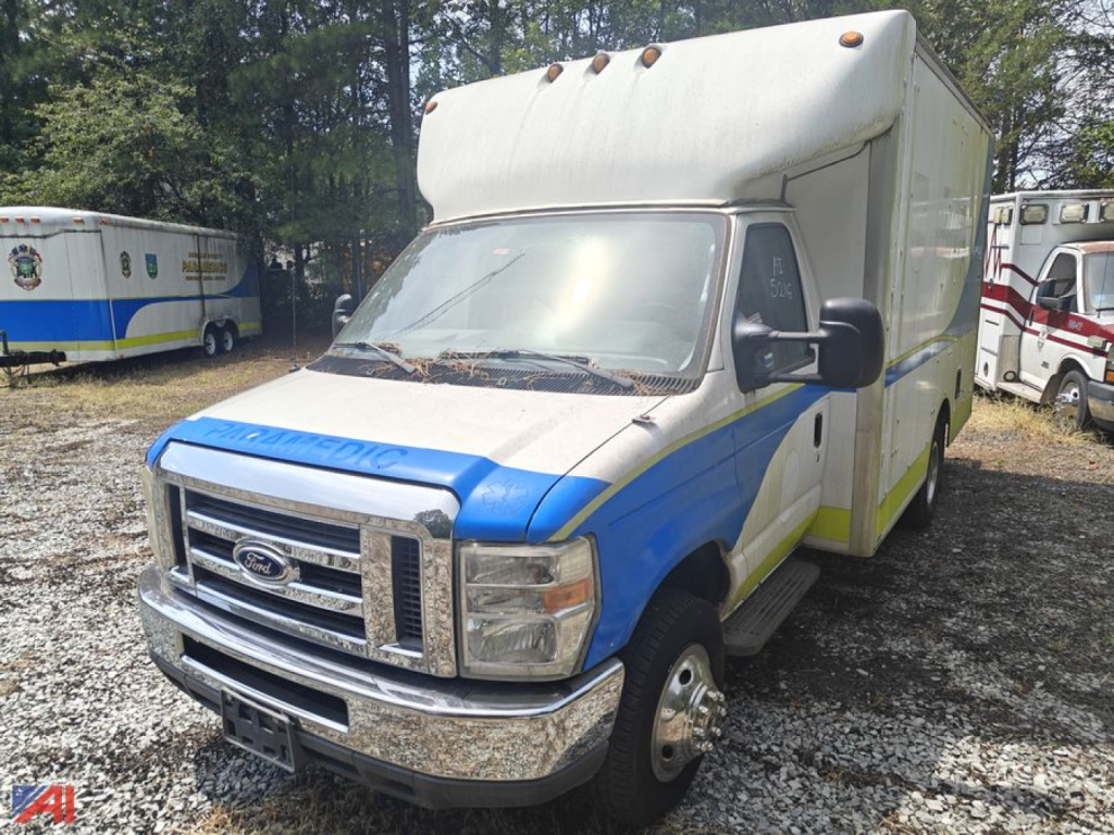 Ford E-350 cargo van with a box truck body, blue and white paint, front grille, and large cargo box.