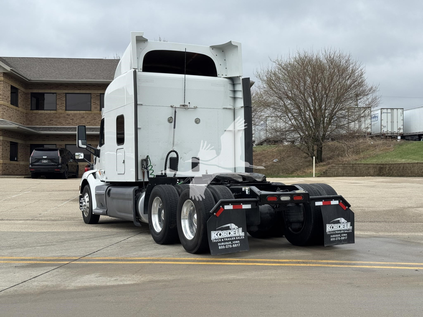 Peterbilt 579 semi-truck tractor rear view showing sleeper cab and dual rear axles.