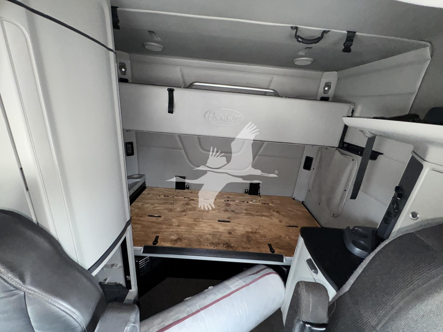 Peterbilt 579 truck interior cargo area with storage cabinet and wood floor panel visible