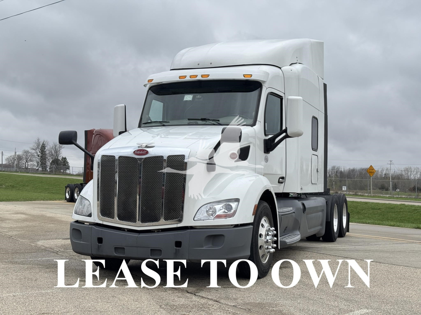 Peterbilt 579 truck in white, front view showing large grille and 'LEASE TO OWN' watermark across image.