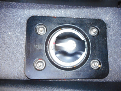 Western Star 49X fuel cap panel with circular locking cap and four screws in a black textured surface.