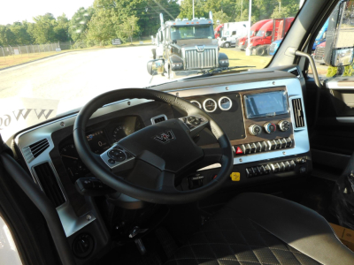 Western Star 49X interior cab view showing steering wheel, dashboard with touchscreen, gauges, and controls.