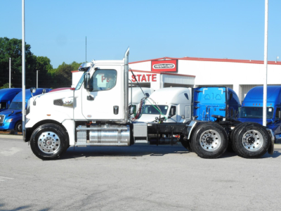 Western Star 49X truck cab and chassis in bright white with chrome fuel tanks parked on lot