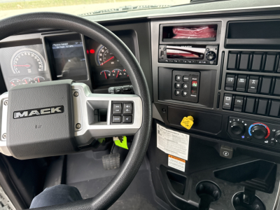 Mack GR64B truck dash and steering wheel showing control cluster and gauges.
