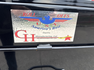 CHD Roll Offs USA emblem plate on Mack GR64B truck showing Roll Offs USA America's Best and CH Manufacturing logo