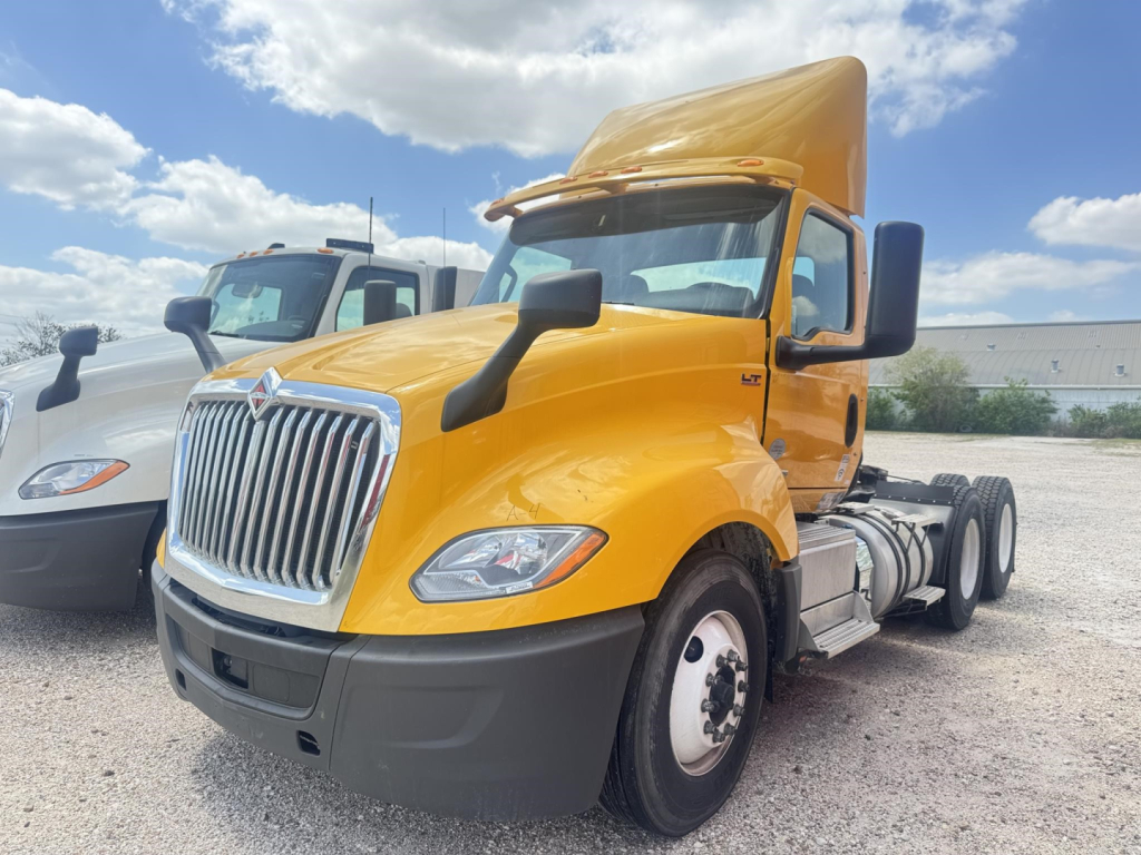2019 International LT daycab truck with yellow cab and raised sleeper, front view showing grille, headlights, and dual rear axles.