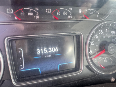 Truck dashboard showing 315,306 miles on digital odometer, analog gauges for RPM/PSI and speed, fuel gauge, and DEF gauge.