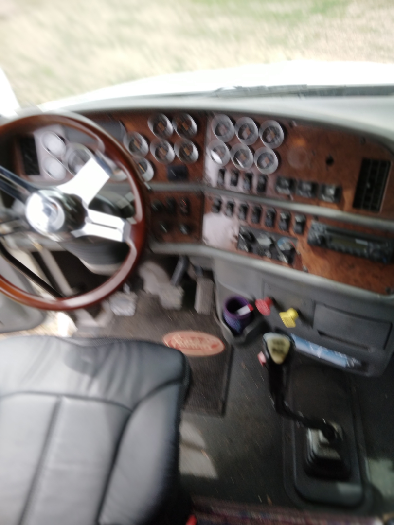 Peterbilt 387 cabin dashboard and steering wheel interior view.