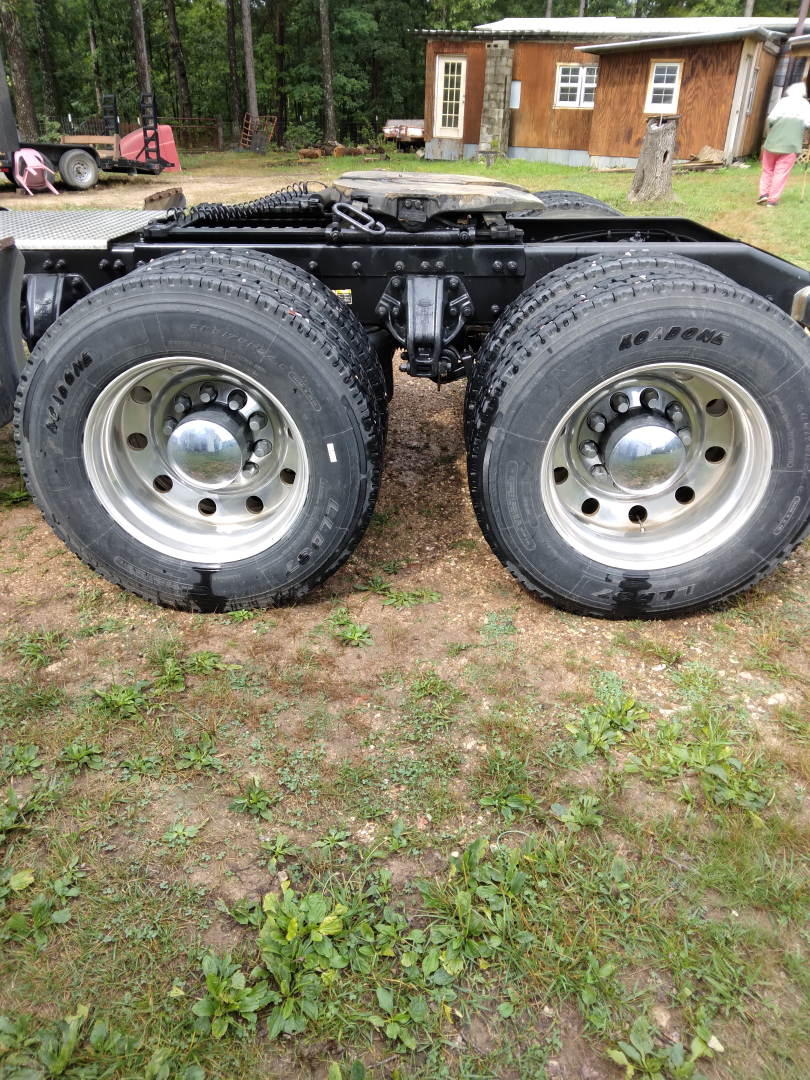 Dual rear wheels of a Peterbilt 387 truck chassis showing large tires and chrome center caps.