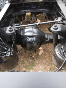 Peterbilt 387 rear view showing spacing and axle components in chassis; differential housing and suspension elements visible between rear axles.