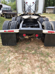 Peterbilt 387 tractor rear view showing fifth wheel mounting and dual axle сonfiguration with multiple tires