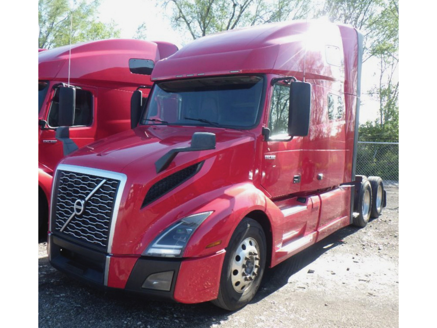 Volvo VNL 760 truck in red color, front-left view showing sleeper cab and dual rear axles.