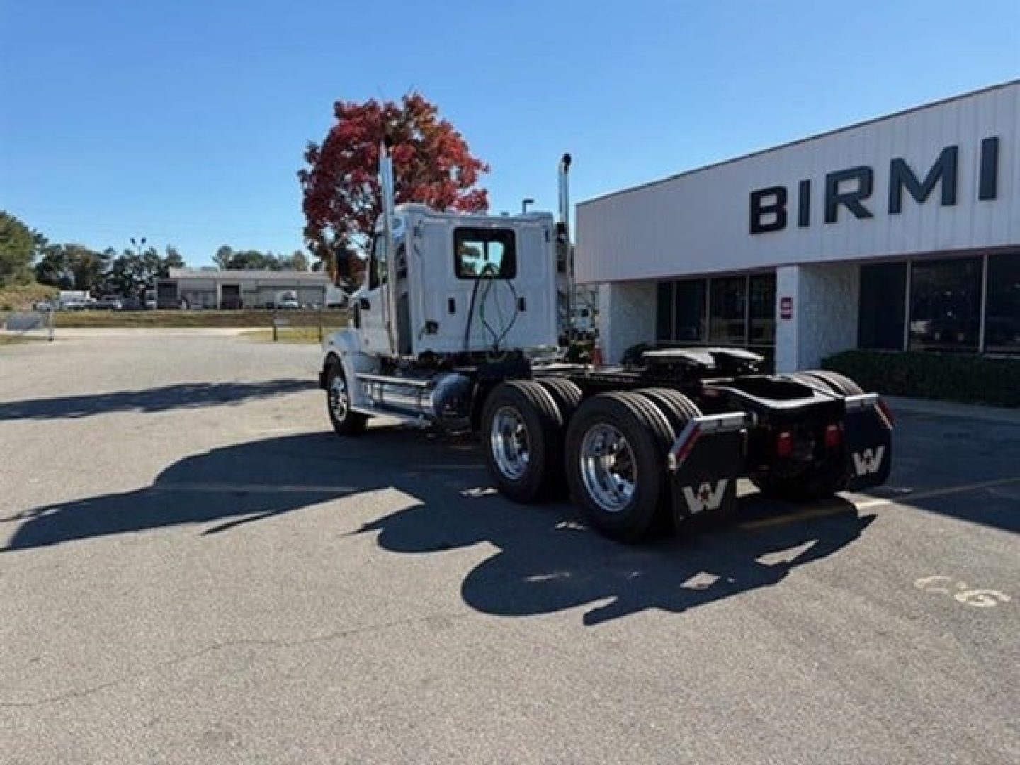 West Star 49X truck chassis in lot showing cab and rear axle with fifth wheel and dual rear tires