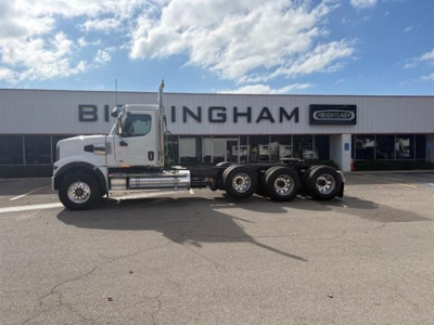 Western Star 49X day cab truck side view in lot with Binghamton signage in background.