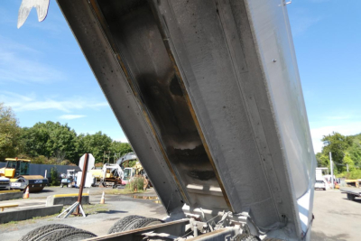 Dump truck bed in raised position showing metal framework and hydraulic hinge for Mack RD688S truck bed.