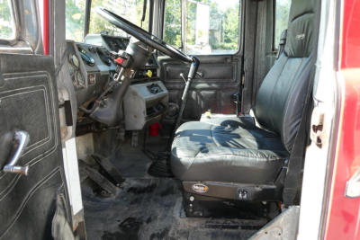 Truck cab interior showing driver seat and dashboard of a Mack RD688S dump truck.