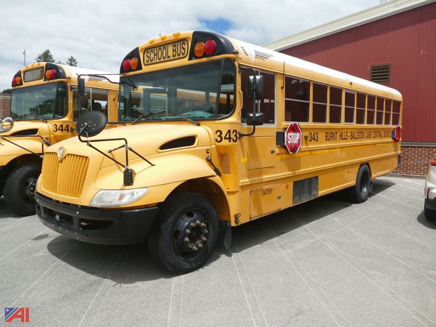 School bus with wheelchair lift showing 343 and STOP sign on the side, front view, 2017 International CE 300 bus.