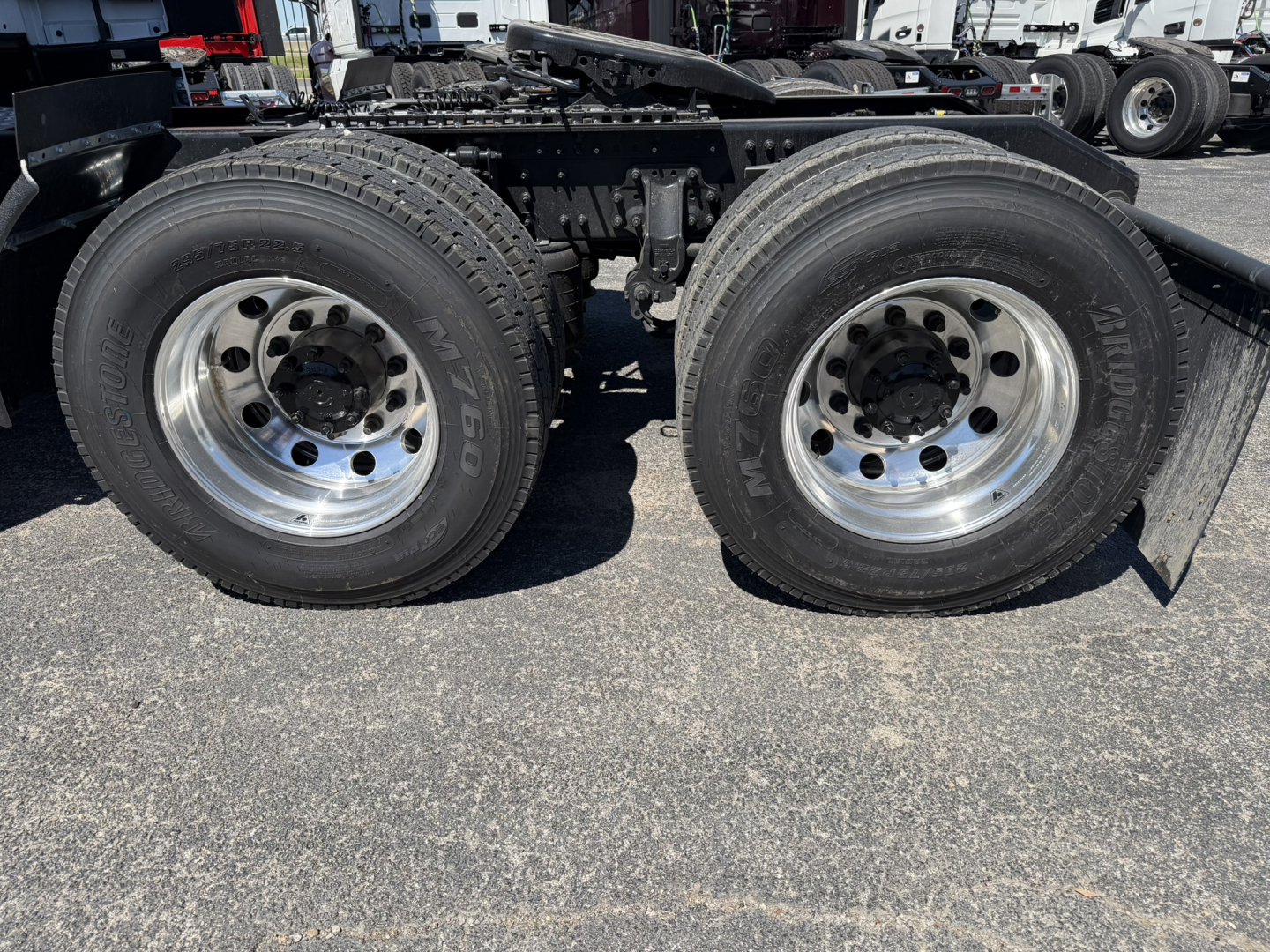 Mack PR64T76H tractor dual rear wheels showing aluminum rims and tires.