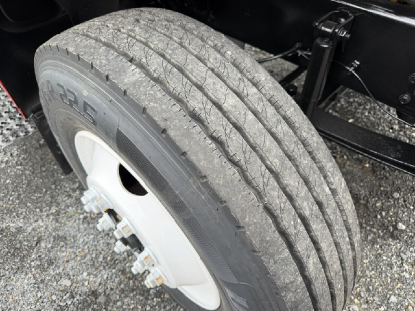 Ford F750 wheel with tire and part of the chassis; tread and rim visible.