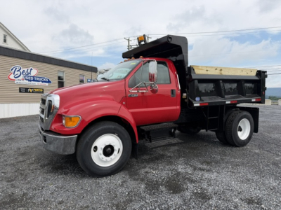Truck image: red 2006 Ford F750 dump truck with black dump bed, front grille, and dual rear wheels.
