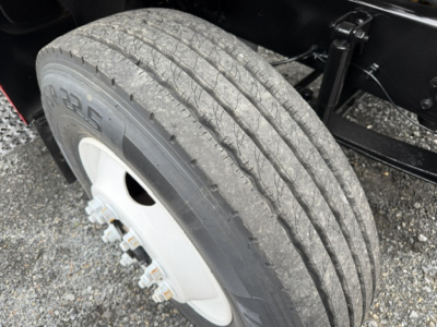 Ford F750 wheel with tire and part of the chassis; tread and rim visible.