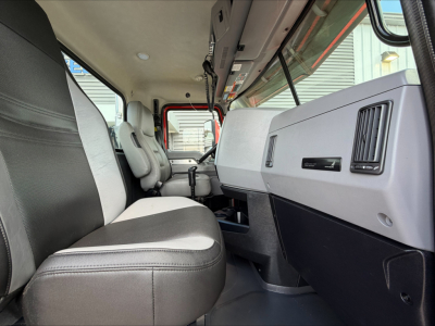 Interior cab view of a 2022 Mack Anthem daycab showing driver seat, steering column, dashboard with vents, glove compartment, and center console.