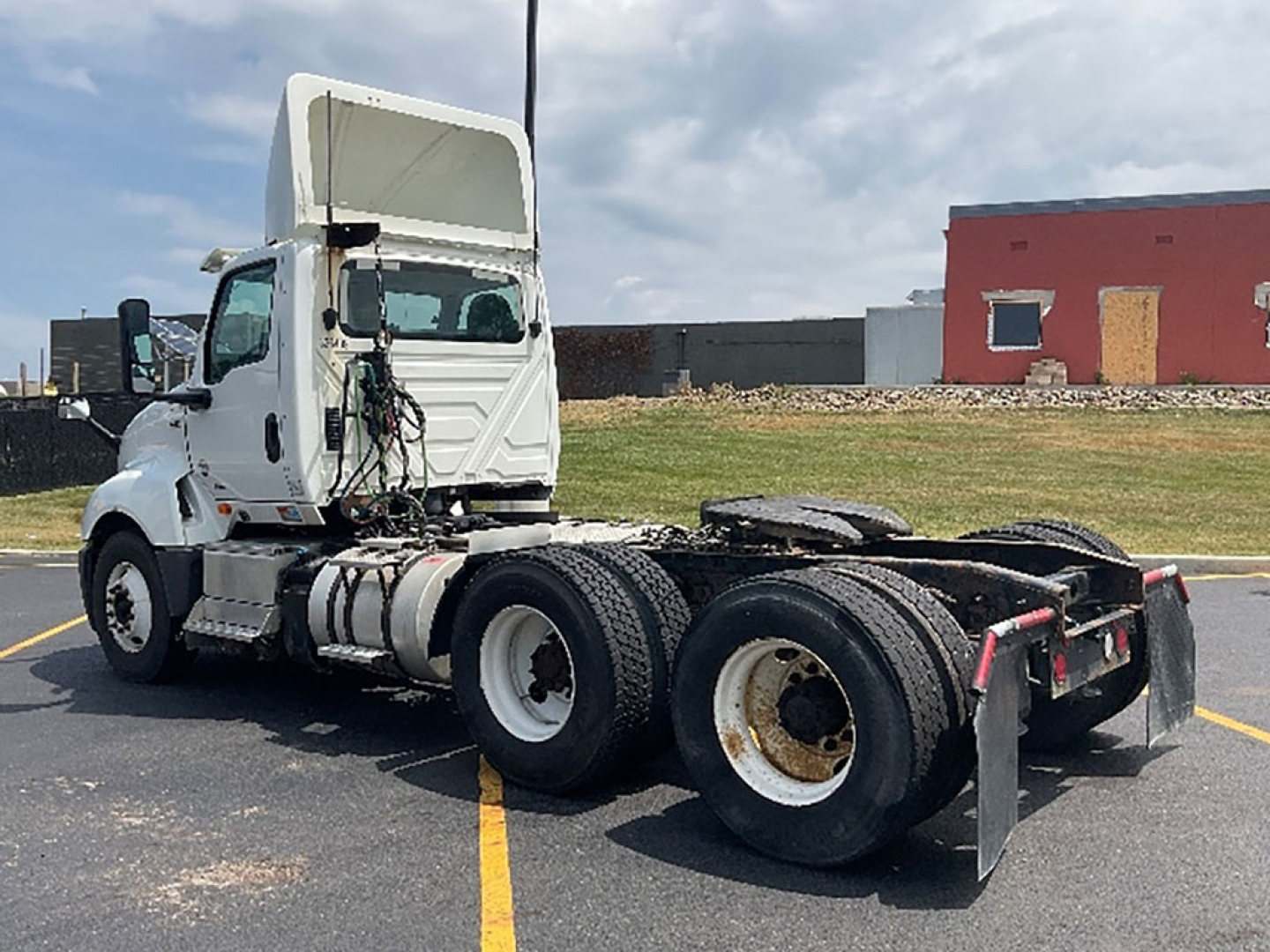 Truck chassis and cab of a 2019 International LT625 daycab tractor, side view, rear wheels and fifth wheel area visible; white cab, dual rear axles, no trailer attached.