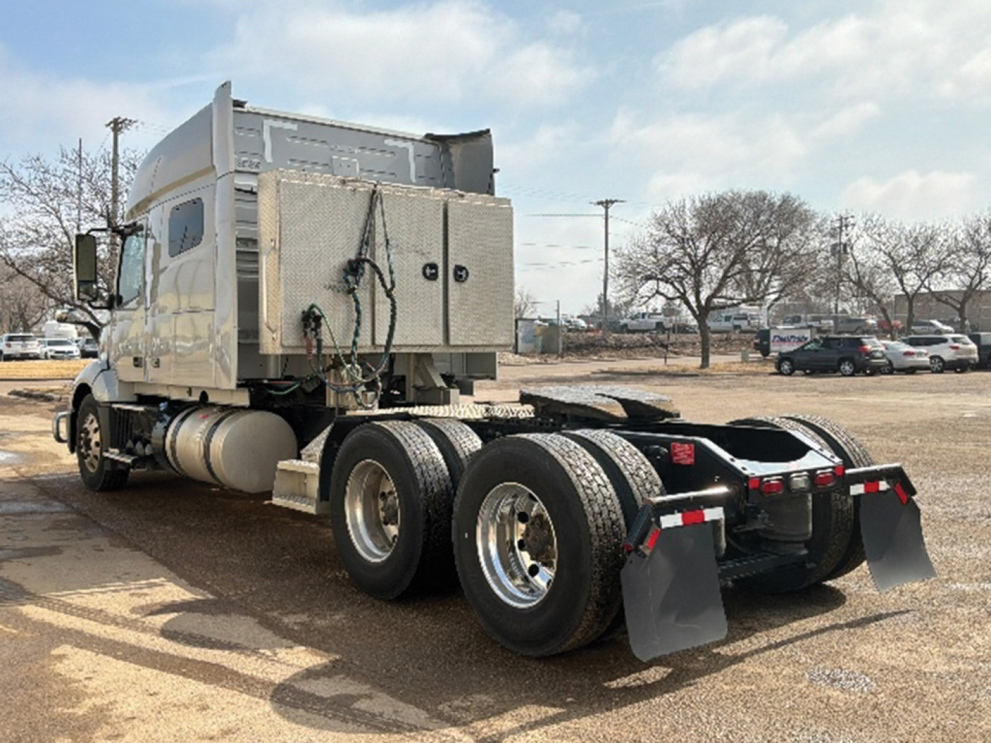 Volvo VNL 740 truck rear/side view showing tractor chassis with dual rear axles and silver fuel tanks