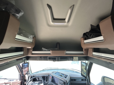 Interior of 2027 Mack PR64T76H sleeper cab showing dashboard and overhead storage compartments.