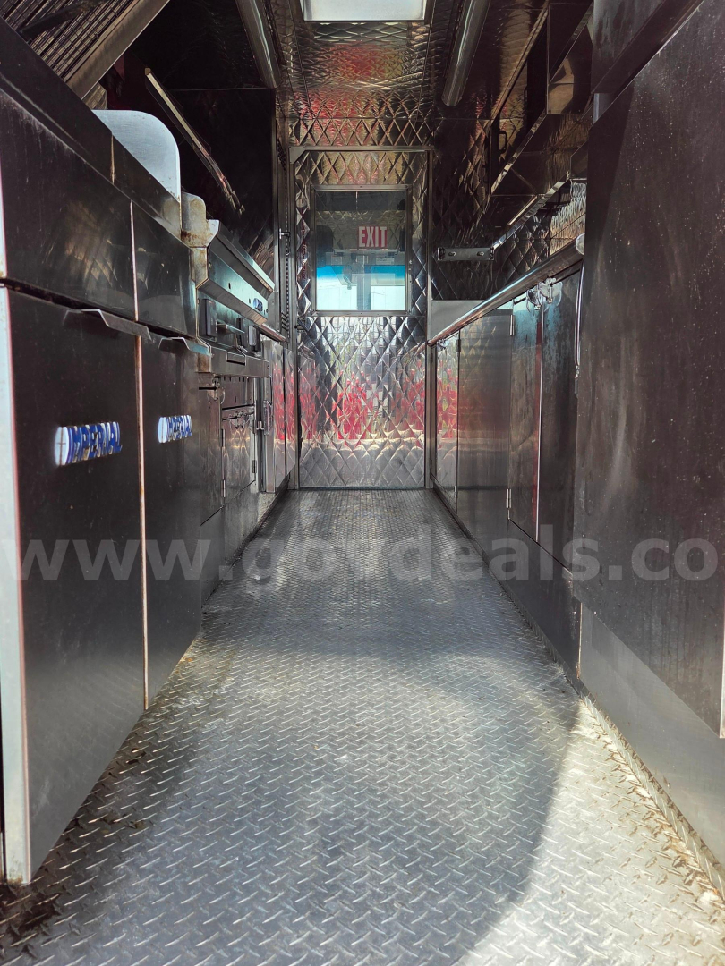 Ford food truck interior showing stainless steel counters and diamond plate floor.