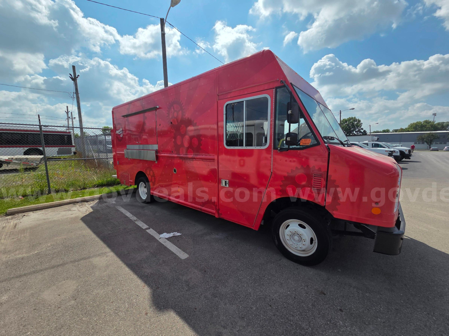 Food truck exterior: red 2020 Ford box truck converted for catering with side service window. VIN 1F65F5KN9L0A19180.