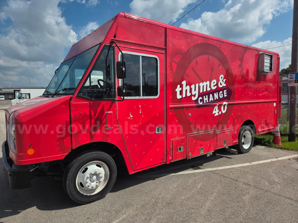 Food truck exterior showing red body with thyme & change 40 branding on side and front cab.
