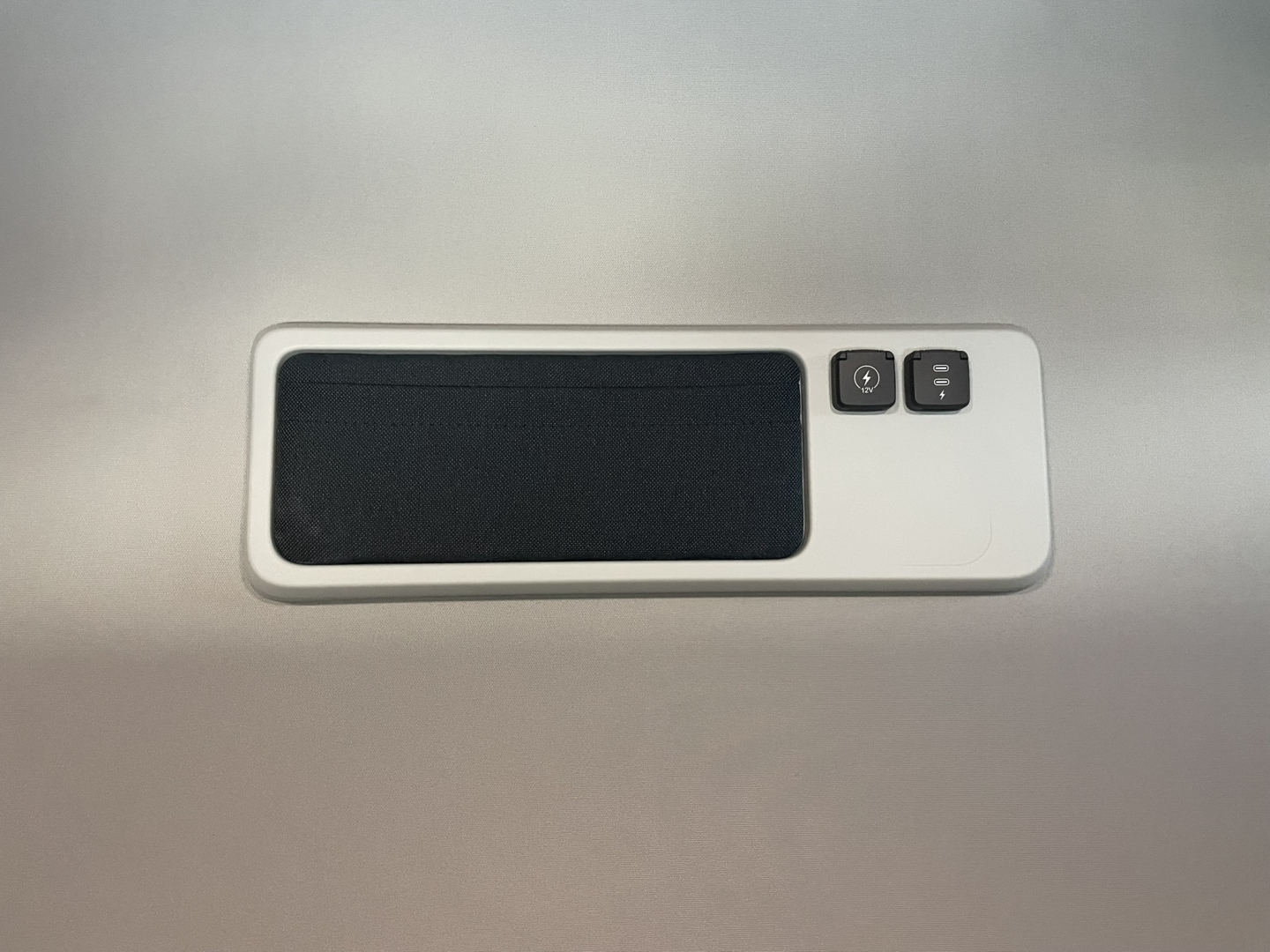 Volvo truck interior panel with speaker and control buttons.